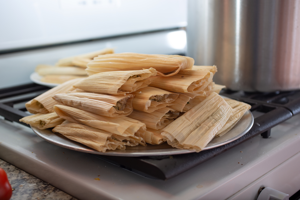 fresh tamales stacked on grey plate
